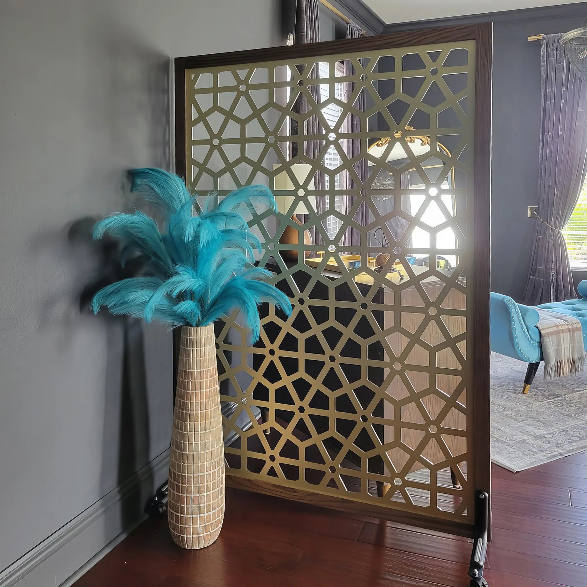 Decorative room divider with geometric pattern in a living room setting.